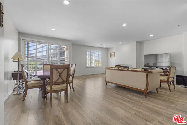 a living room with furniture a wooden floor and a window