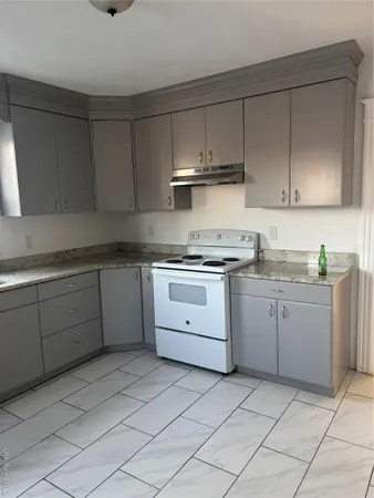 a kitchen with cabinets appliances and a sink