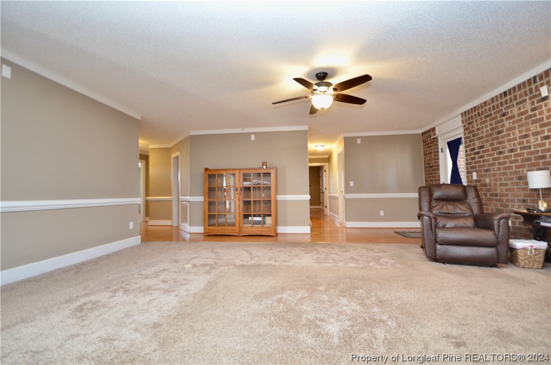 1396 Green Path Road Dunn, NC 28334 - Photo 8 of 50 a view of a livingroom with furniture a ceiling fan and windows