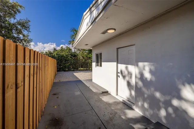 a view of a pathway of a house with a yard