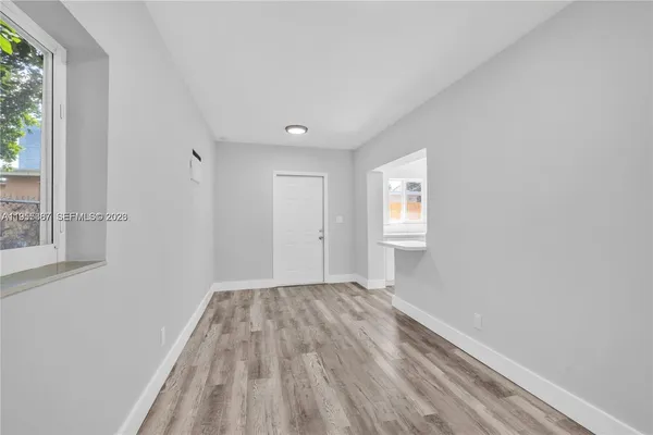a view of room with window and hardwood floor
