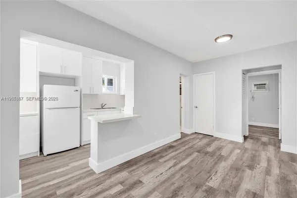 a view of an empty room with closet and a window