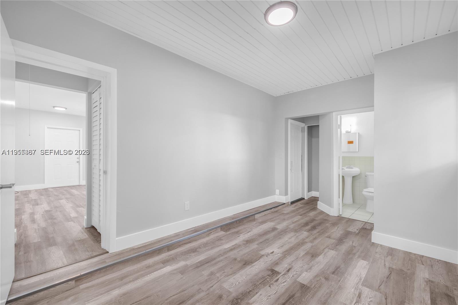 2729 Southwest 18th Street, Unit 2 Miami, FL 33145 - Photo 6 of 9 wooden floor in an empty room with a window