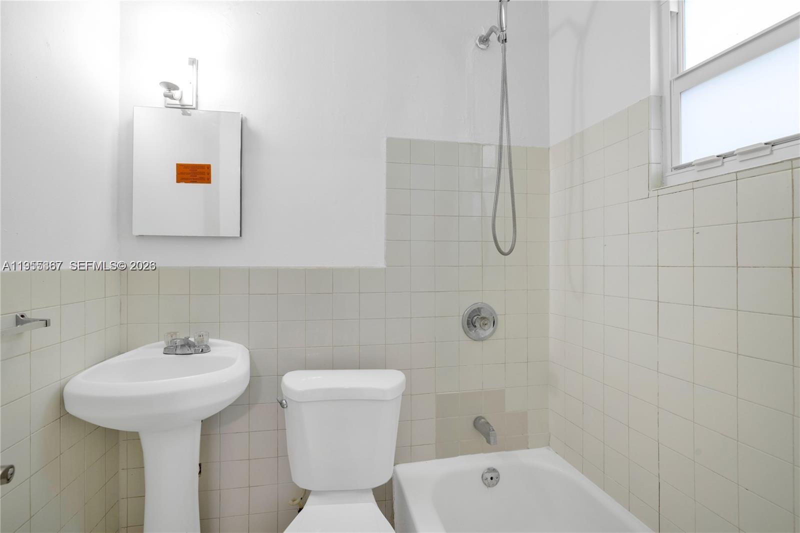 2729 Southwest 18th Street, Unit 2 Miami, FL 33145 - Photo 8 of 9 a bathroom with a sink toilet and shower