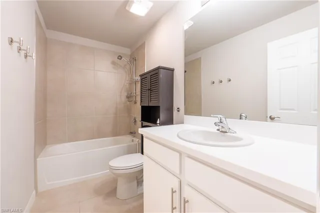 a view of a room with a large window and front door