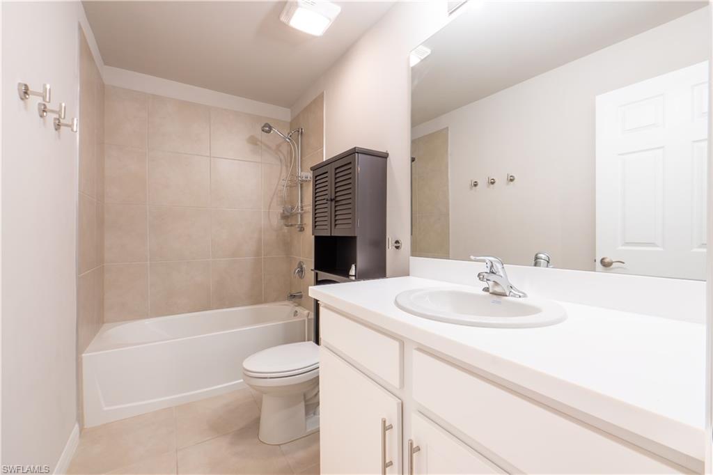 15091 Wildflower Circle Naples, FL 34119 - Photo 11 of 14 a bathroom with a sink a toilet and shower