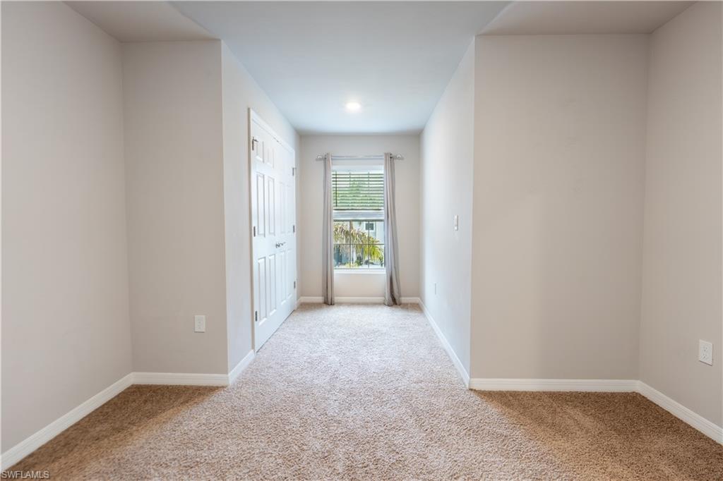 15091 Wildflower Circle Naples, FL 34119 - Photo 12 of 14 an empty room with windows
