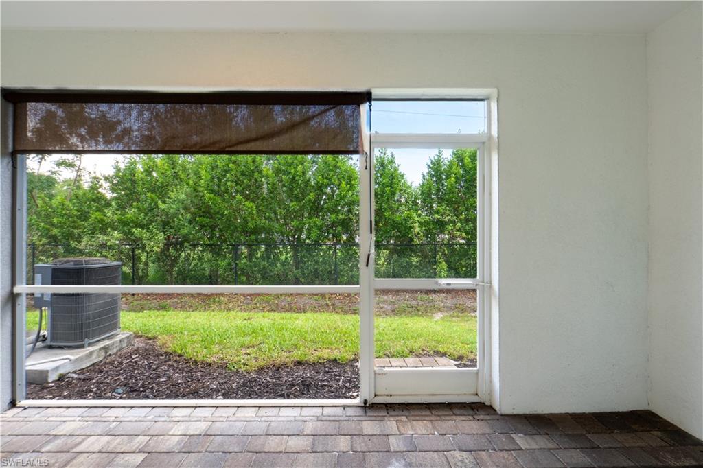 15091 Wildflower Circle Naples, FL 34119 - Photo 13 of 14 a view of a room with a large window and front door
