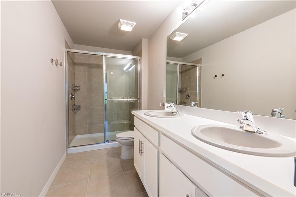 15091 Wildflower Circle Naples, FL 34119 - Photo 8 of 14 a bathroom with a sink a toilet and shower