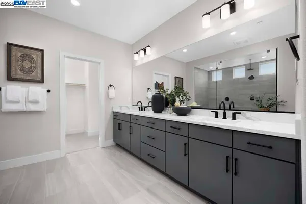 a bathroom with double sink and a mirror