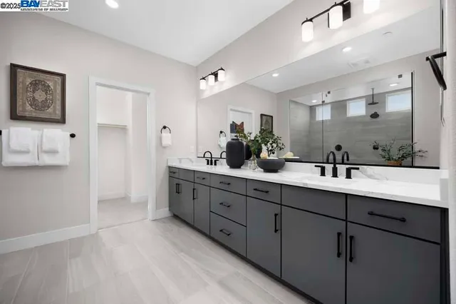 a bathroom with double sink and a mirror