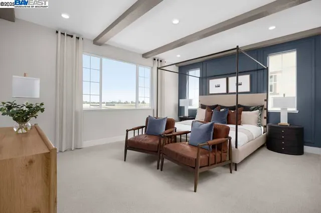 a spacious bedroom with a bed and a couch