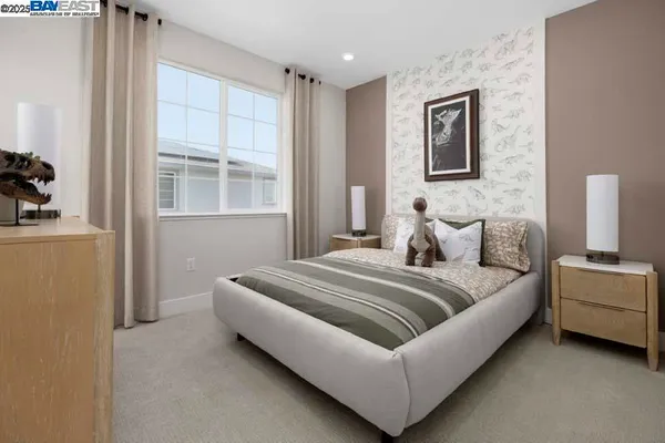 a spacious bedroom with a bed and a window