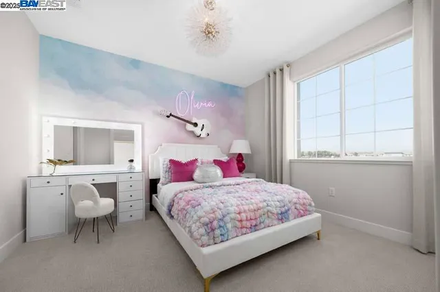 a bedroom with a bed and a table chair