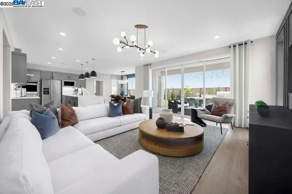 a living room with furniture potted plant and a large window