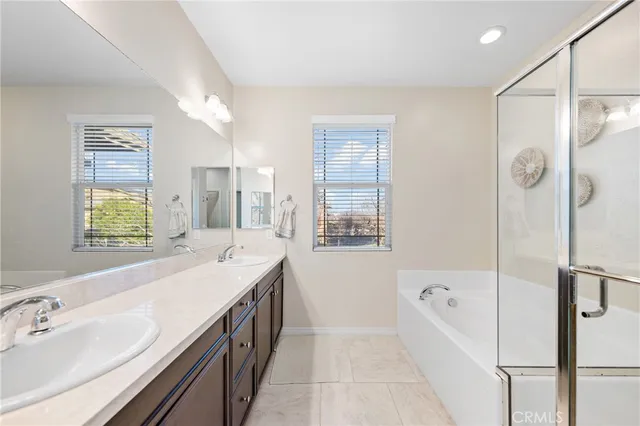a bathroom with a tub sink and mirror