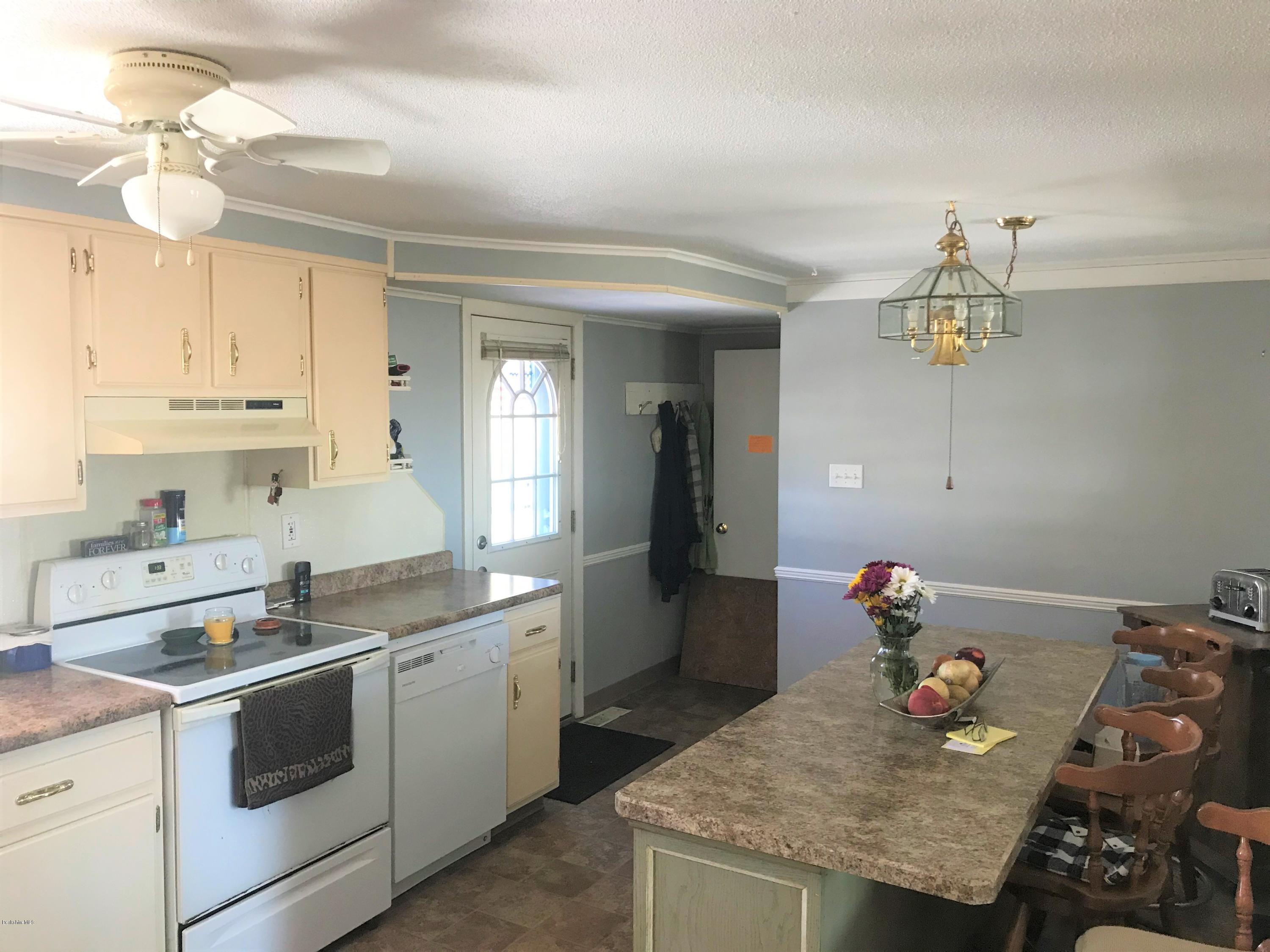 98 Loop Road Savoy, MA 01256 - Photo 7 of 20 a kitchen that has a lot of cabinets in it and wooden floor