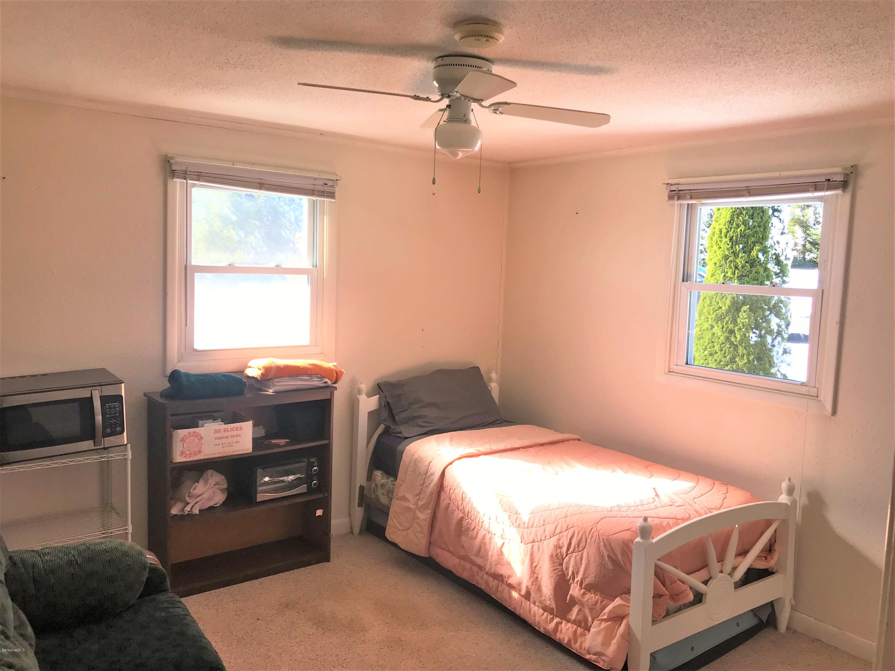 98 Loop Road Savoy, MA 01256 - Photo 9 of 20 a bedroom with a bed and a window
