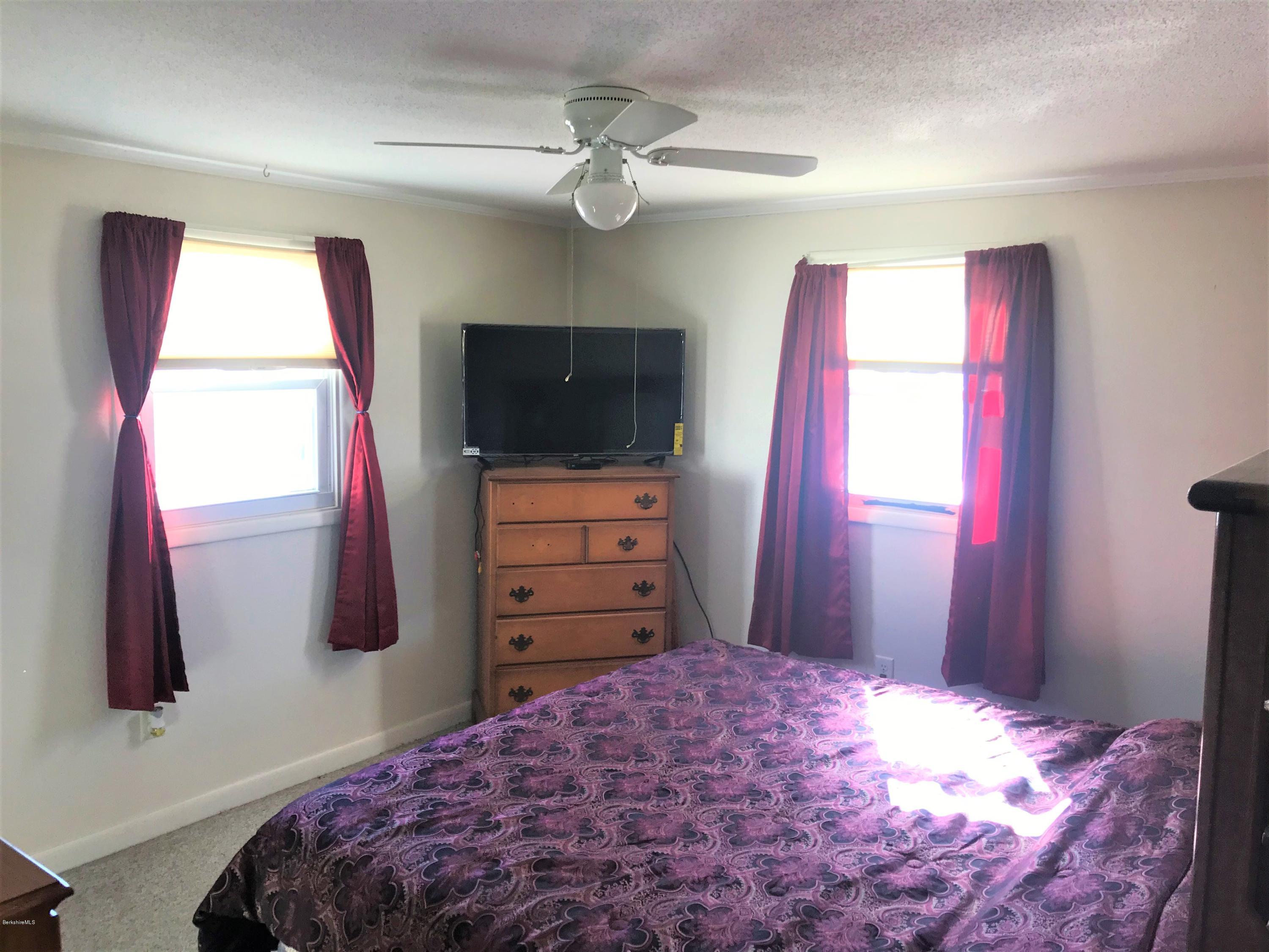 98 Loop Road Savoy, MA 01256 - Photo 10 of 20 a bedroom with a bed and a flat screen tv