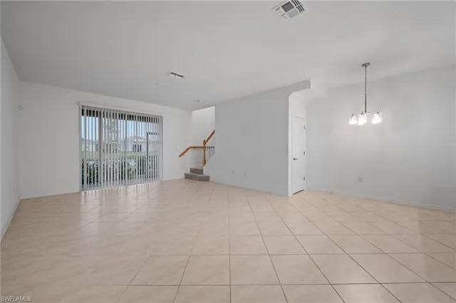an empty room with fireplace and windows
