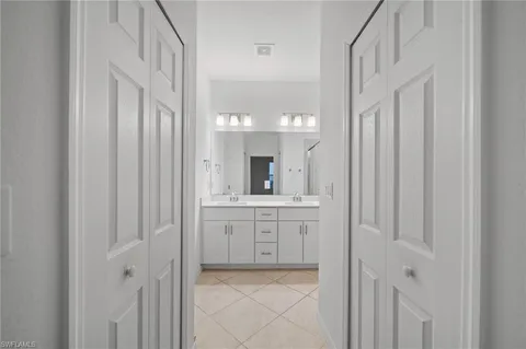 a bathroom with a double vanity sink and a mirror