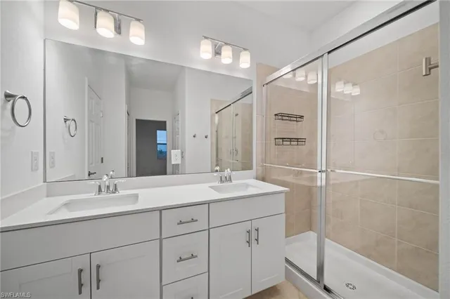 a bathroom with a shower sink double and mirror