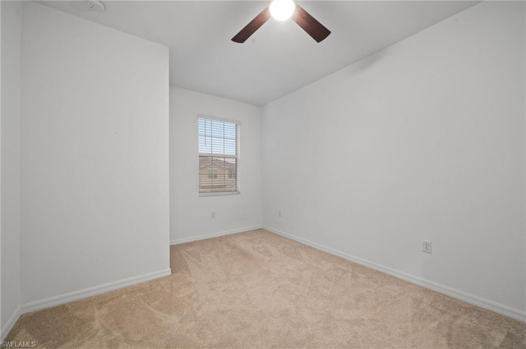 2878 Blossom Way Naples, FL 34120 - Photo 31 of 41 an empty room with a empty space and windows