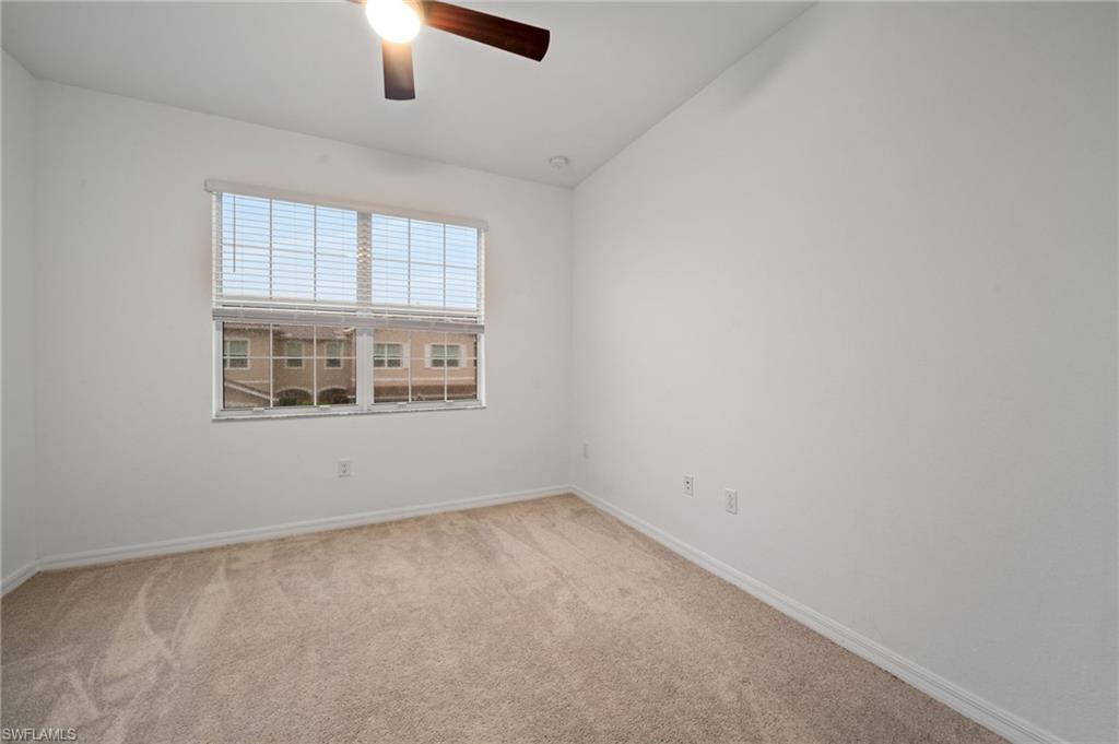 2878 Blossom Way Naples, FL 34120 - Photo 33 of 41 an empty room with ceiling fan and window