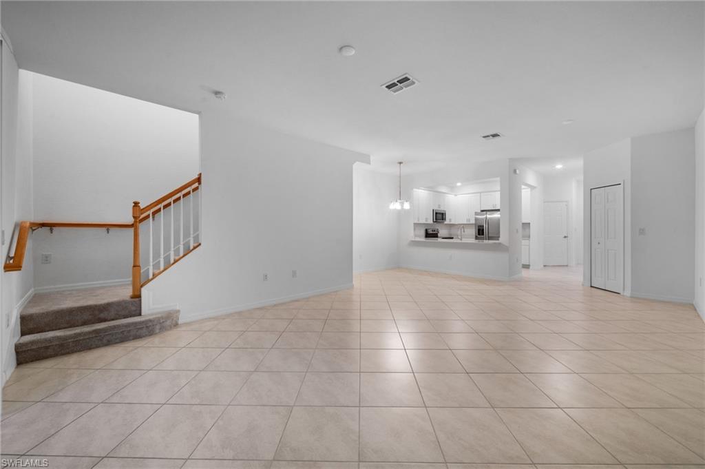 2878 Blossom Way Naples, FL 34120 - Photo 7 of 41 a view of a hallway with a kitchen
