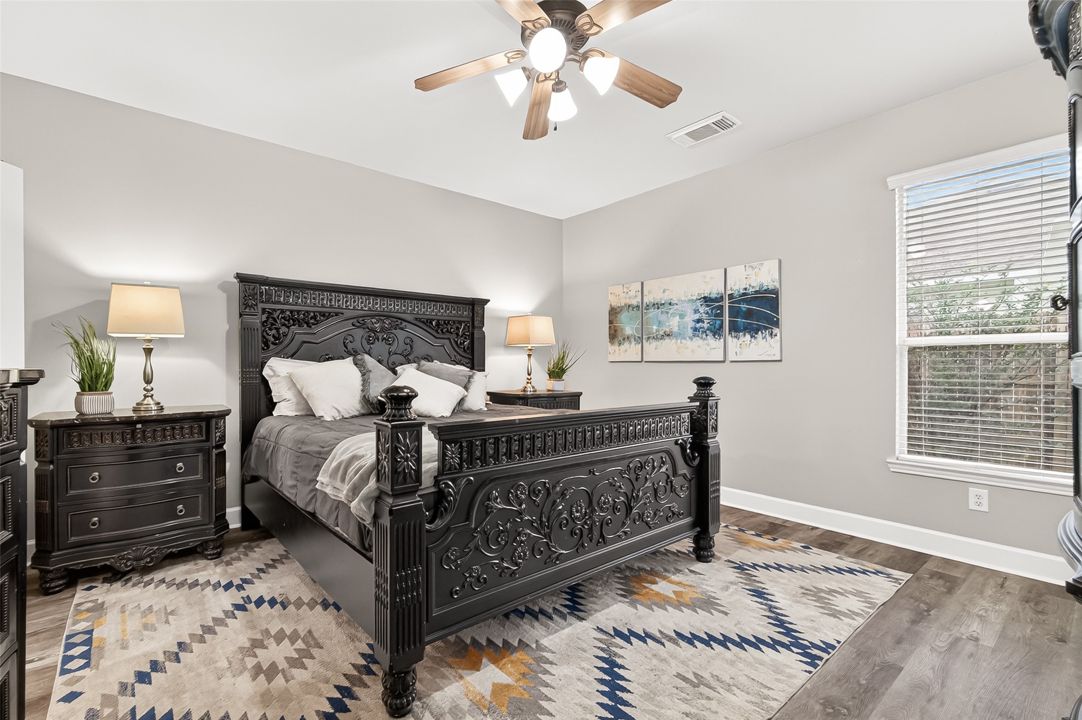 7415 Riven Oaks Court Cypress, TX 77433 - Photo 21 of 42 Spacious primary bedroom with large windows that fill the retreat with abundant natural light, creating a bright and relaxing atmosphere.