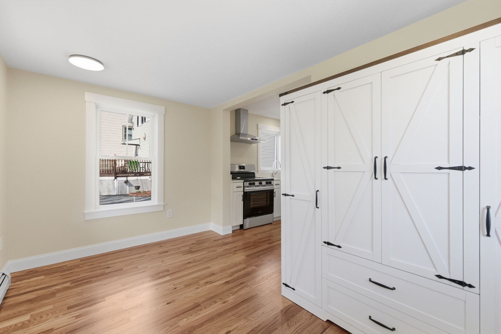 20 Beacon Street, Unit 1 Gloucester, MA 01930 - Photo 11 of 17 a view of a hallway with wooden floor and closet area