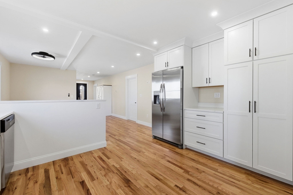 20 Beacon Street, Unit 1 Gloucester, MA 01930 - Photo 5 of 17 a kitchen with granite countertop a refrigerator and a sink