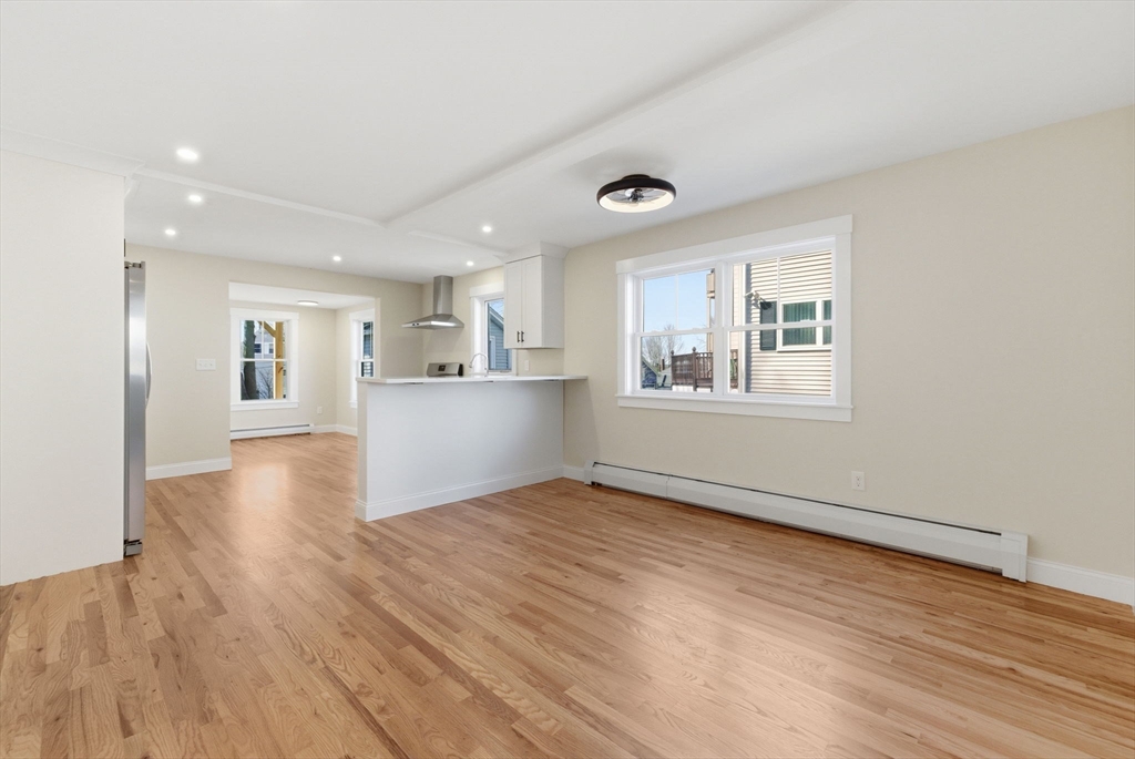 20 Beacon Street, Unit 1 Gloucester, MA 01930 - Photo 6 of 17 a view of an empty room with wooden floor and a window