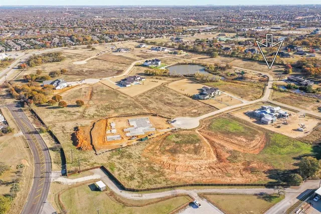 an aerial view of residential houses with yard