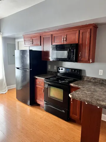 a kitchen with stainless steel appliances granite countertop a stove a refrigerator and a sink