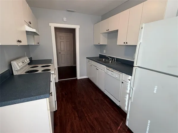 a kitchen with a stove and a refrigerator