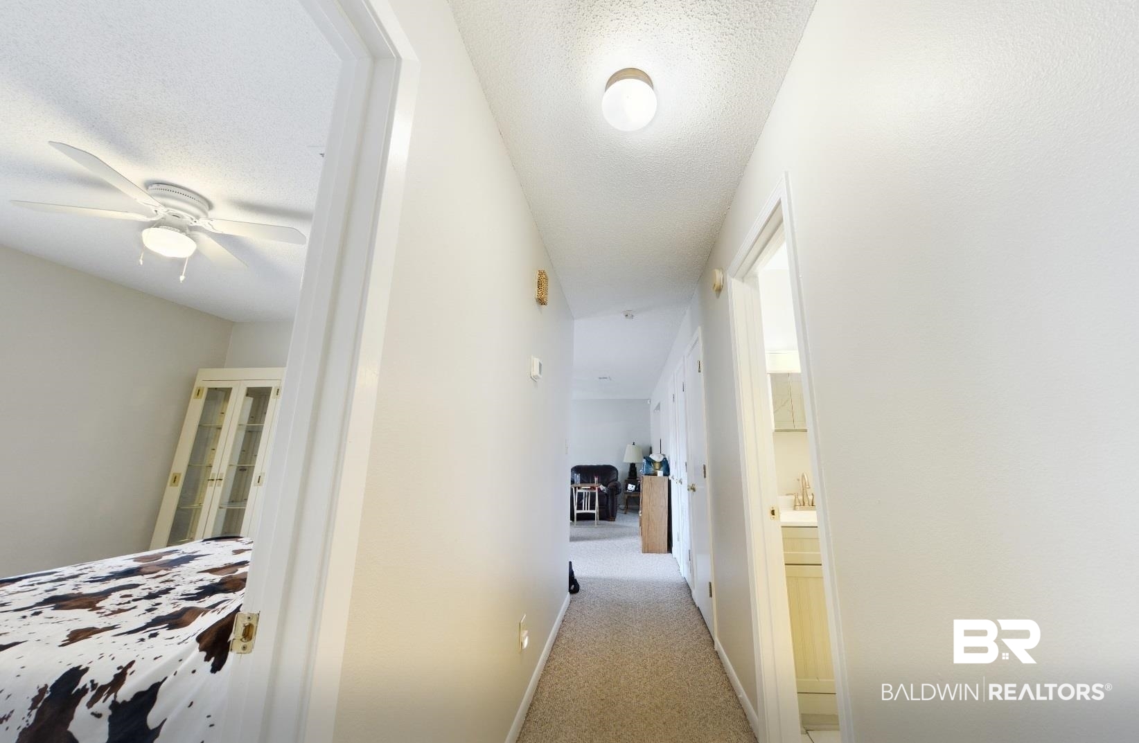 15148 Highland Circle Foley, AL 36535 - Photo 34 of 47 Corridor featuring light colored carpet, a textured ceiling, and baseboards