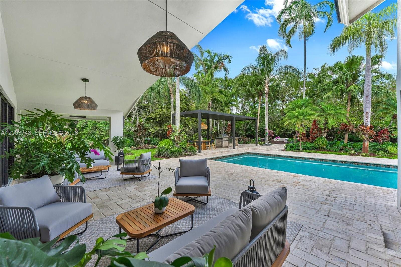 2675 Hackney Road Weston, FL 33331 - Photo 28 of 61 a view of a patio with couches a table and chairs and potted plants