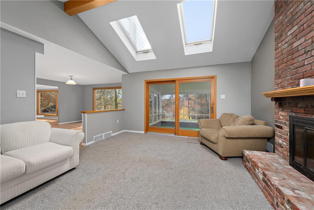 8210 Bramble Lane Pittsburgh, PA 15237 - Photo 11 of 25 a living room with furniture a fireplace and a large window