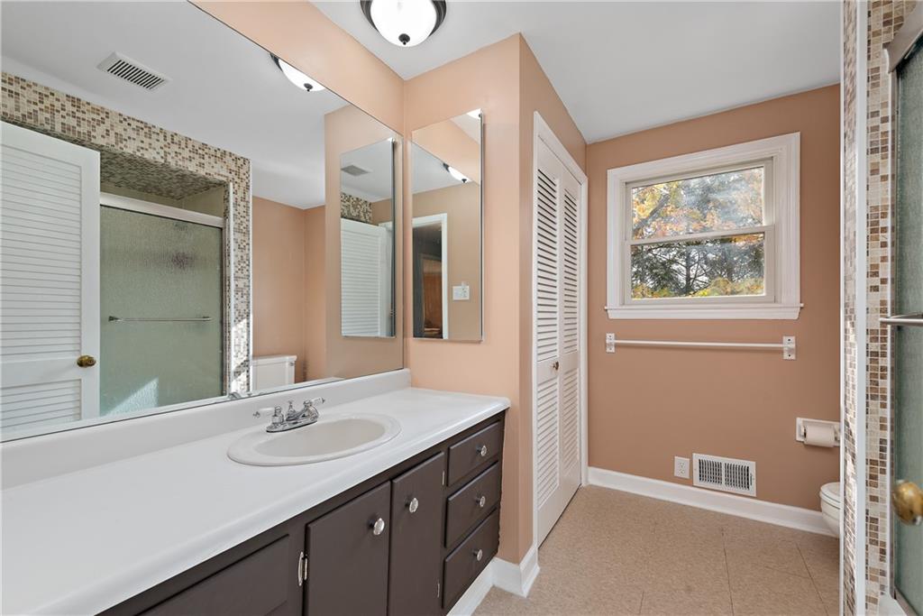 8210 Bramble Lane Pittsburgh, PA 15237 - Photo 22 of 25 a bathroom with a double vanity sink a mirror and a shower