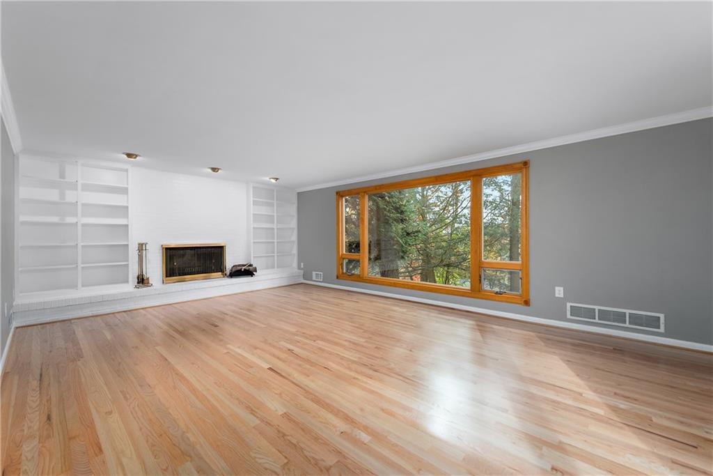 8210 Bramble Lane Pittsburgh, PA 15237 - Photo 5 of 25 a view of empty room with wooden floor and fireplace