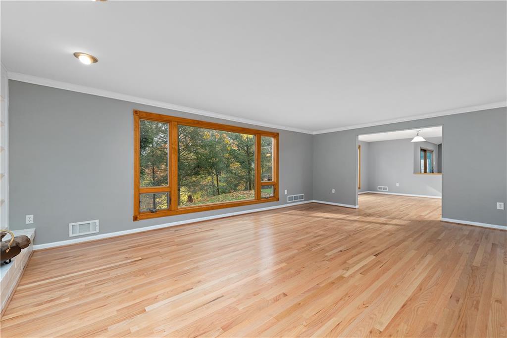 8210 Bramble Lane Pittsburgh, PA 15237 - Photo 6 of 25 a view of an empty room with wooden floor and a window