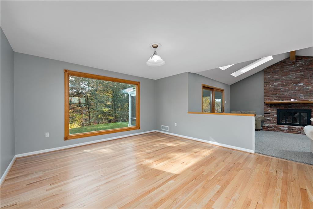 8210 Bramble Lane Pittsburgh, PA 15237 - Photo 10 of 25 a view of an empty room with window and wooden floor