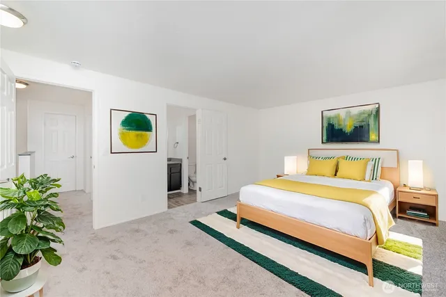 a bedroom with a bed and a potted plant