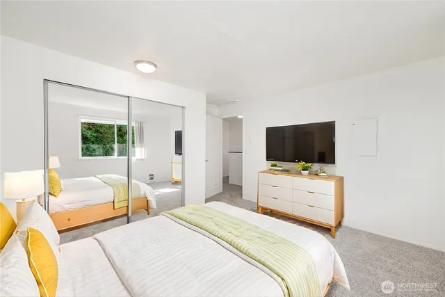 a bedroom with a bed and a flat screen tv