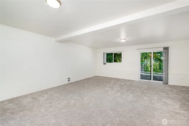 an empty room with windows and yard