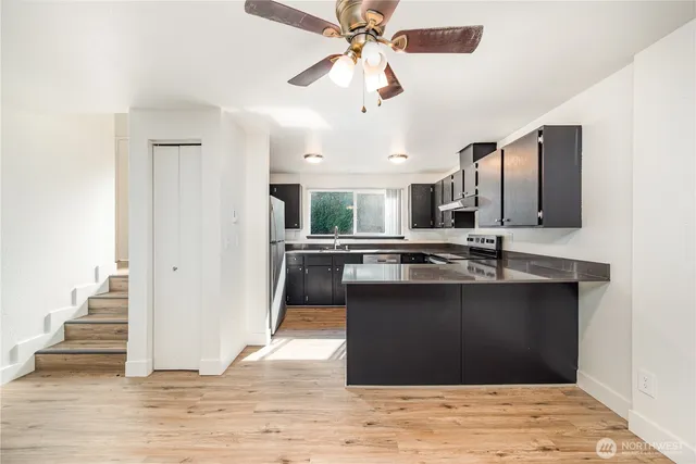 a kitchen with kitchen island granite countertop a stove and a sink