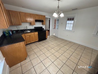 445 Church Street, Unit 2 Wallingford, CT 06492 - Photo 3 of 15 a kitchen with stainless steel appliances granite countertop a stove a sink and a refrigerator