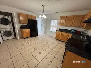 a view of a kitchen with microwave and refrigerator