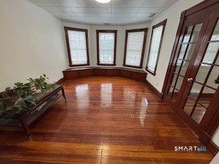 445 Church Street, Unit 2 Wallingford, CT 06492 - Photo 6 of 15 a view of empty room with wooden floor and fan